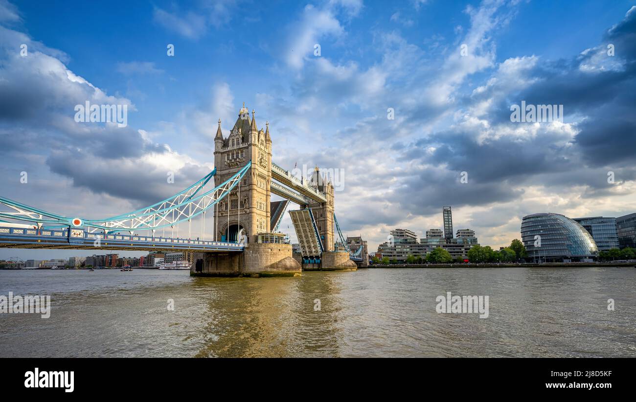 the open tower bridge of london against a dramatic sky Stock Photo