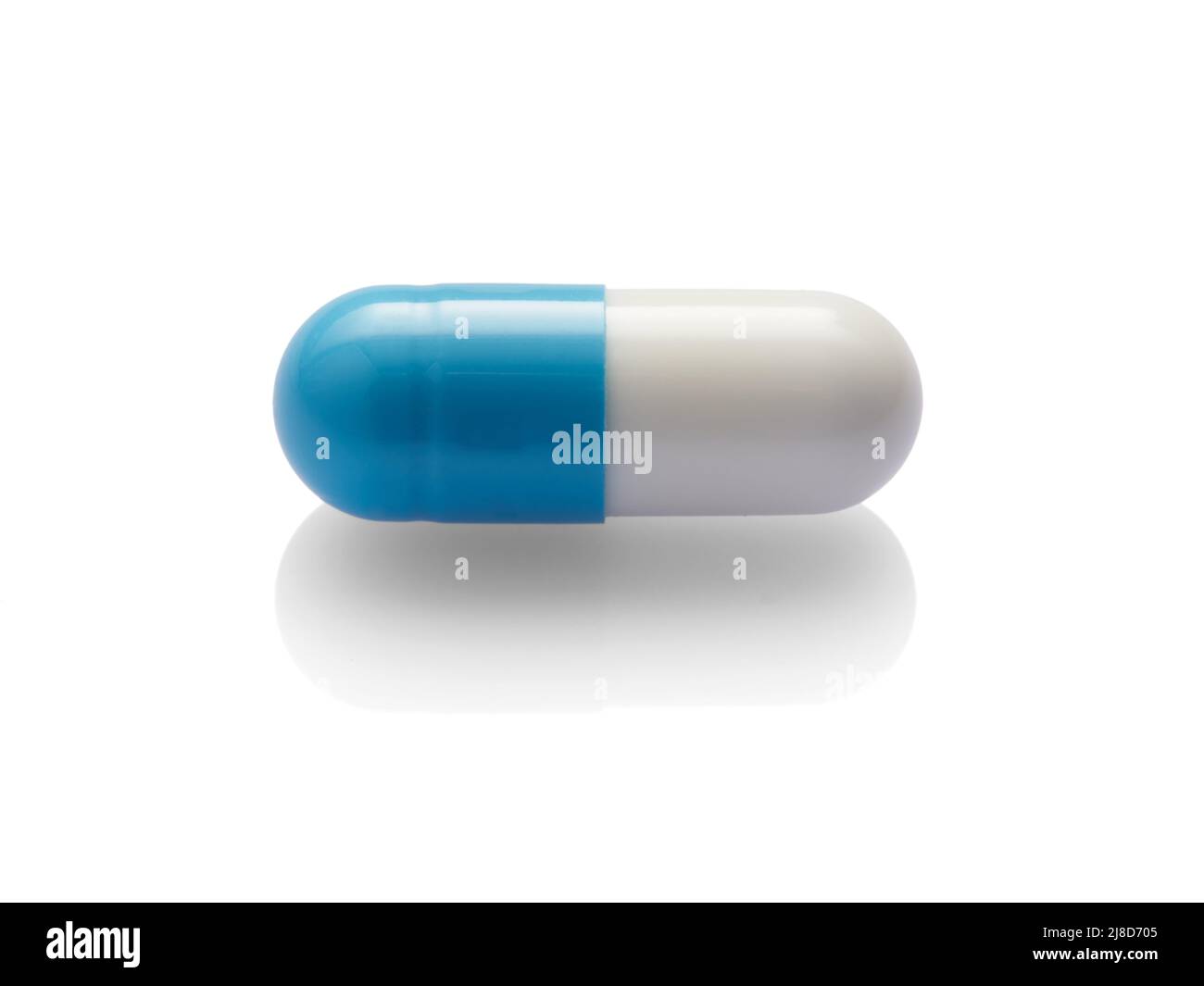 Blue capsule isolated on white background. Stock Photo