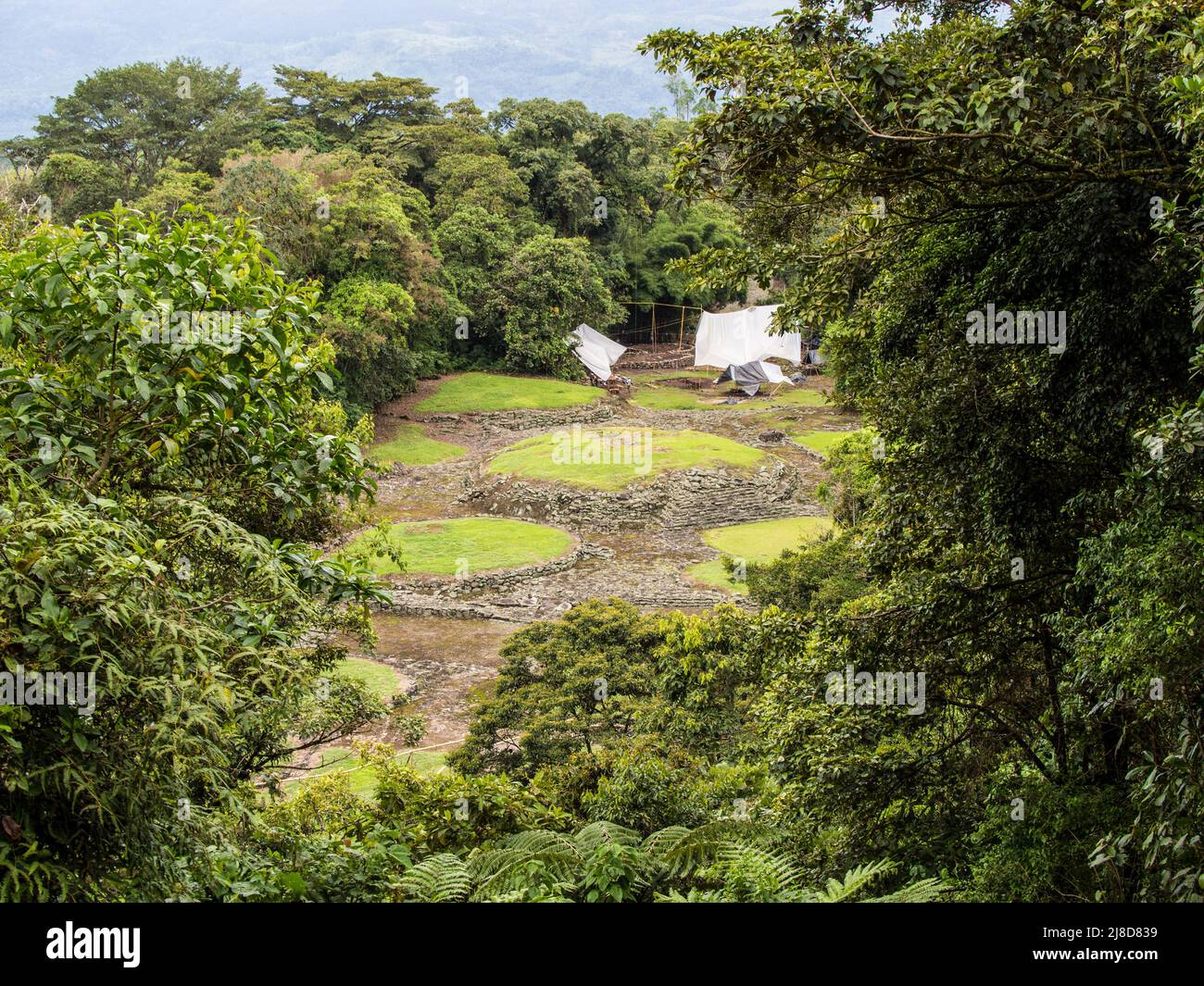 Archaeologists under white tents investigating the Pre-Columbian site of Guayabo near Turrialba, Costa Rica Stock Photo