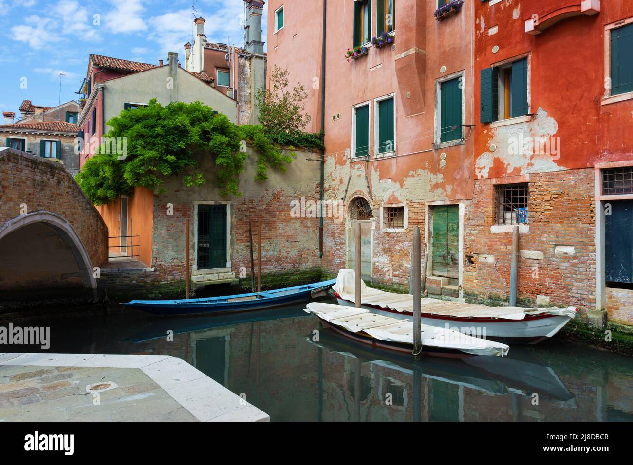 A delightful and original glimpse of a canal in Venice with colorful ...