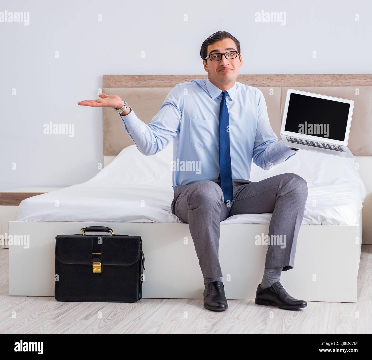 The businessman in the hotel room during travel Stock Photo Alamy