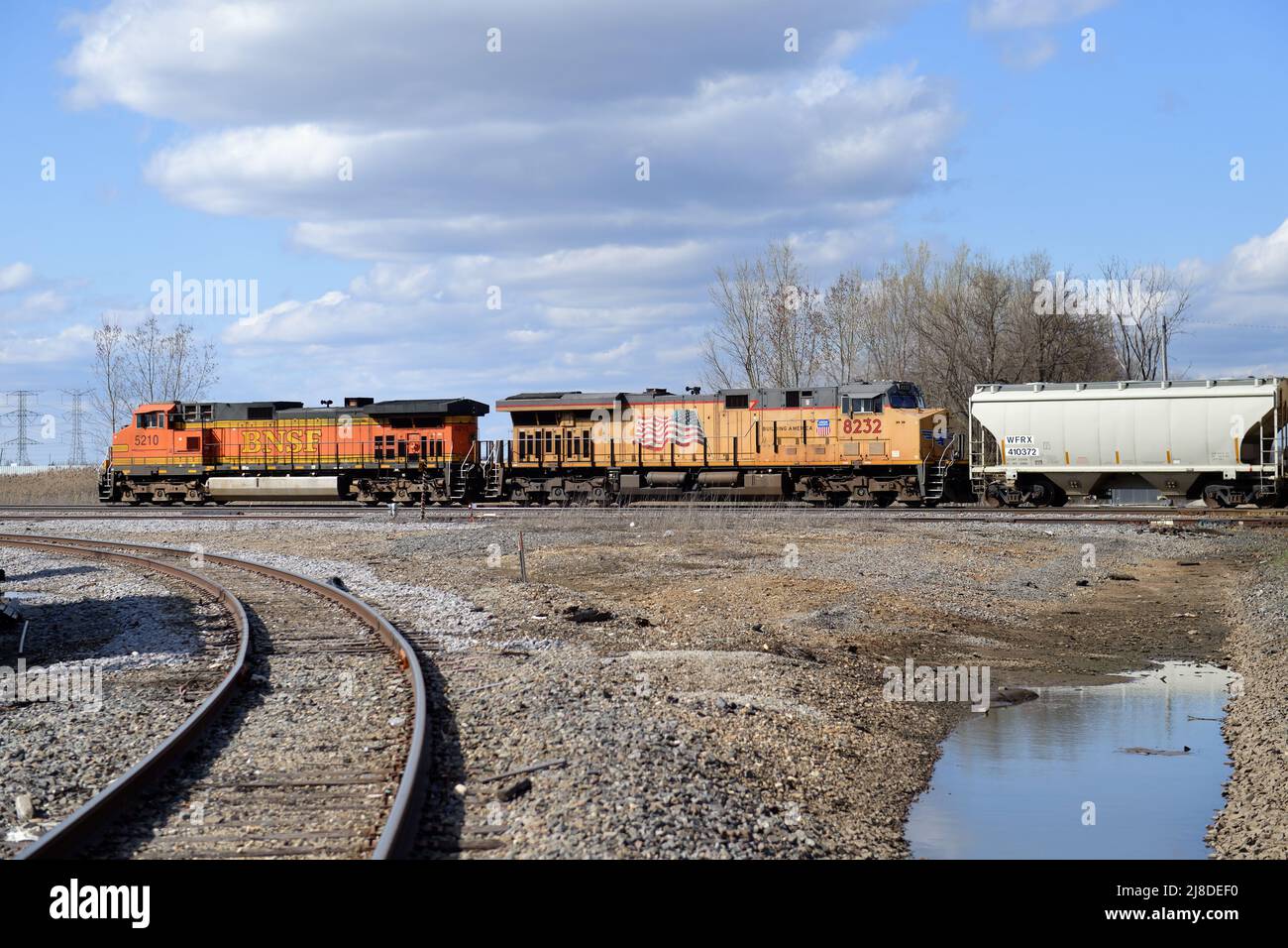 Elgin, Illinois, USA. Two off-road, run-through locomotives, lead a freight train through a railroad junction west of Chicago. Stock Photo