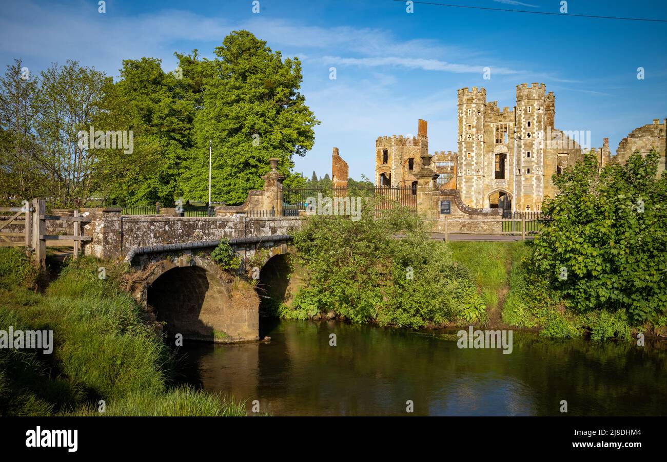 An ancient stone bridge over the River Rother leading to the entrance of Cowdray House Ruins in Midhurst, West Sussex, England, UK. Stock Photo