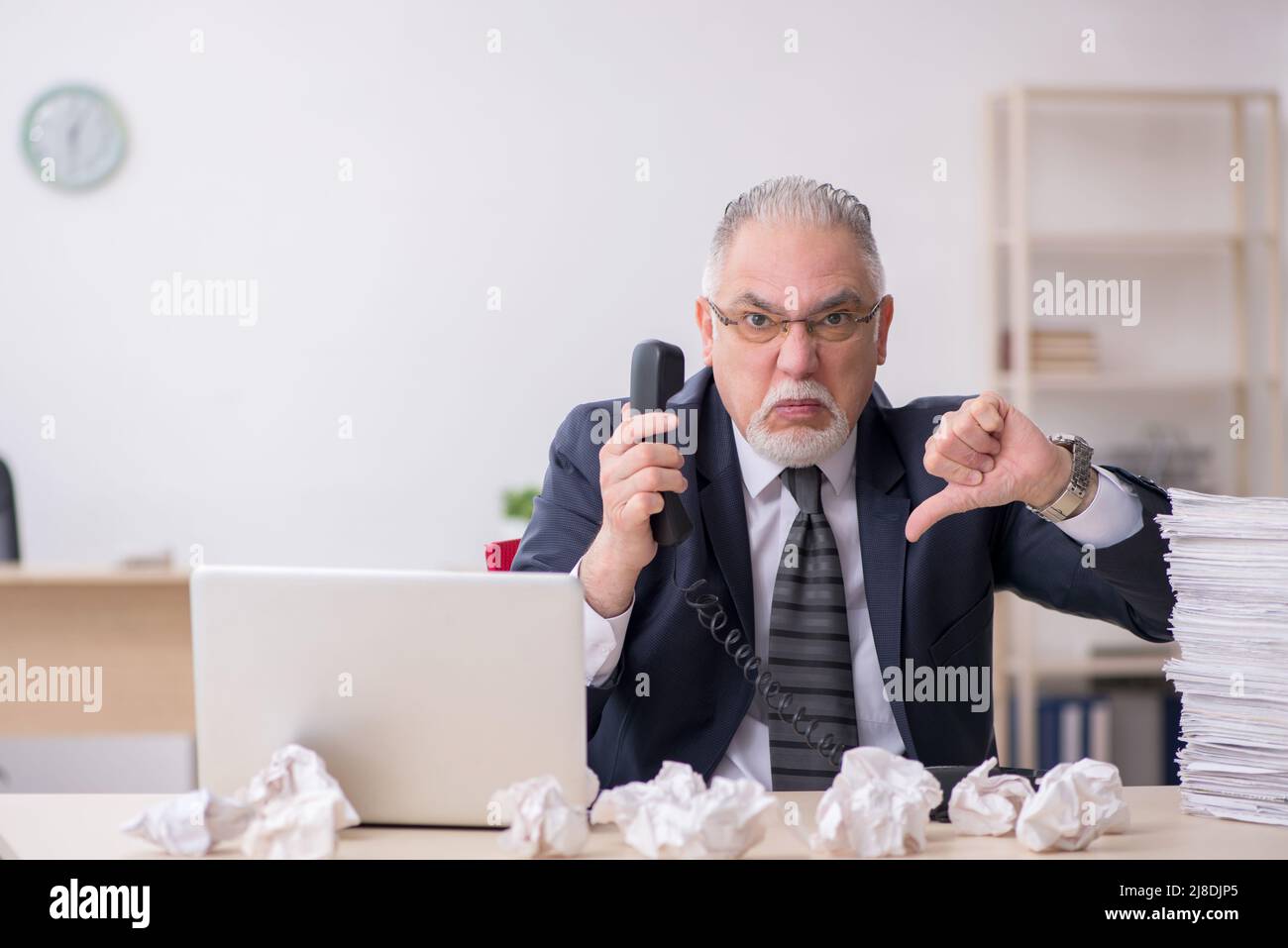 Old businessman employee in brainstorming concept Stock Photo