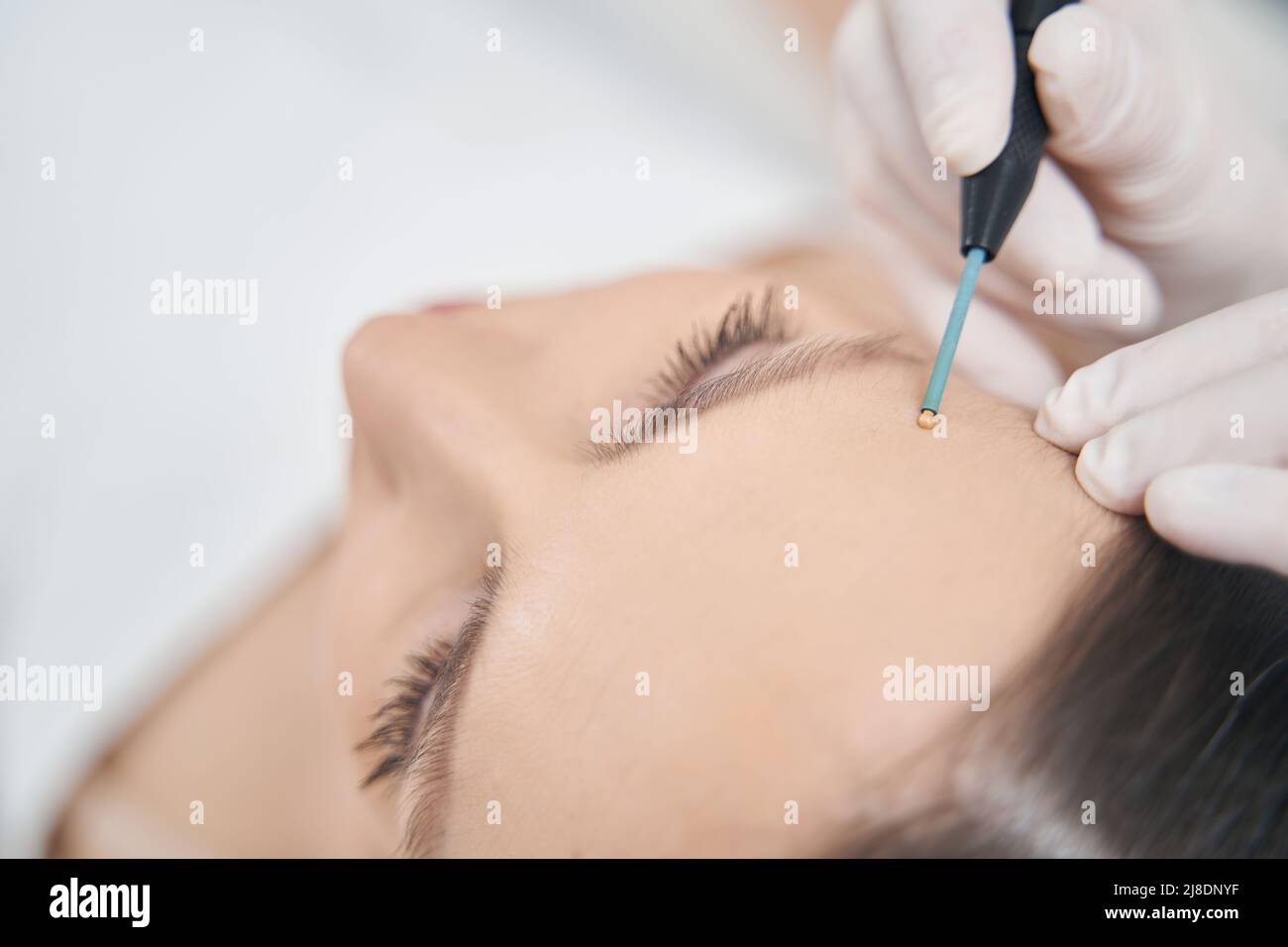Woman receiving skincare treatment in cosmetology clinic Stock Photo