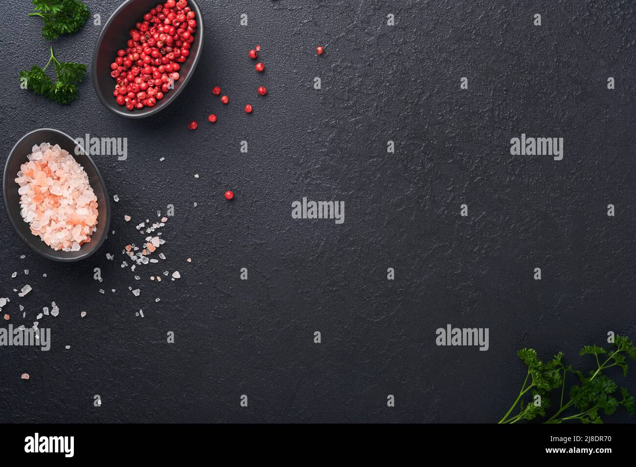 Black food cooking background. Stone texture with sea salt, pepper