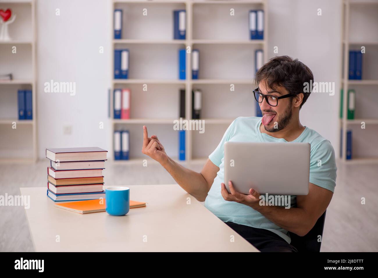 Young student preparing for exams in the classroom Stock Photo - Alamy