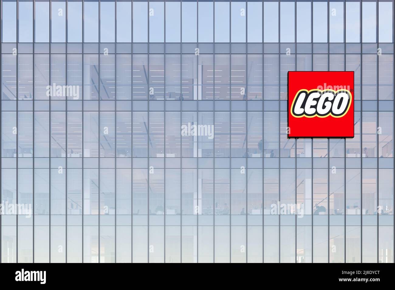 Billund, Denmark. May 2, 2022. Editorial Use Only, 3D CGI. The Lego Group Signage Logo on Top of Glass Building. Workplace Toy Company Office Headquar Stock Photo