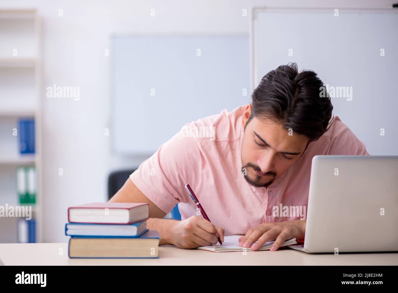 Young student preparing for exams in the classroom Stock Photo - Alamy