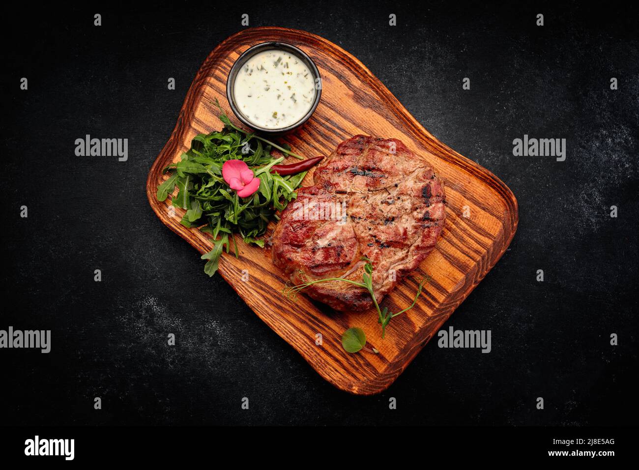 Pork neck steak with sauce and arugula Stock Photo Alamy