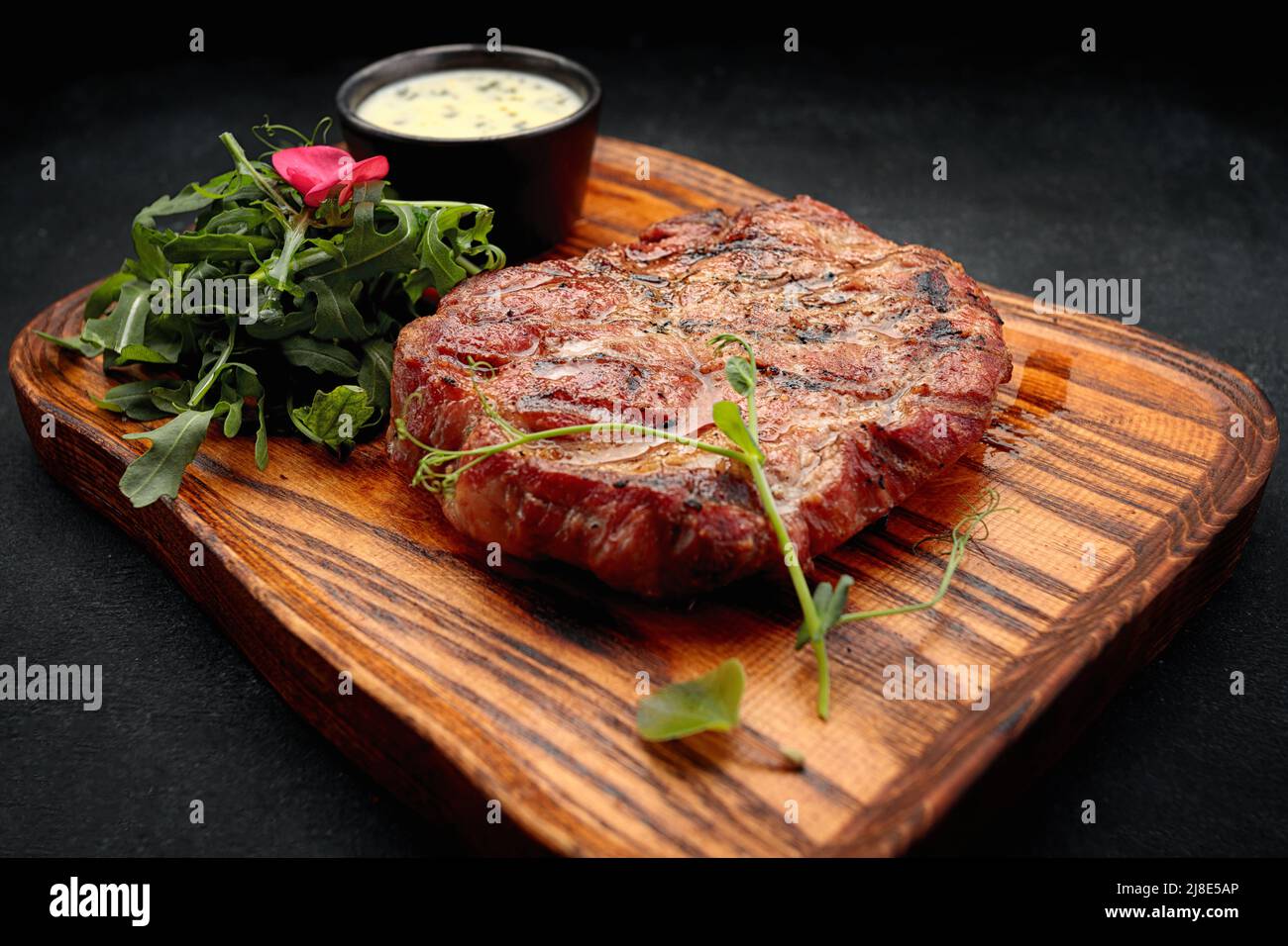 Pork neck steak with sauce and arugula Stock Photo Alamy