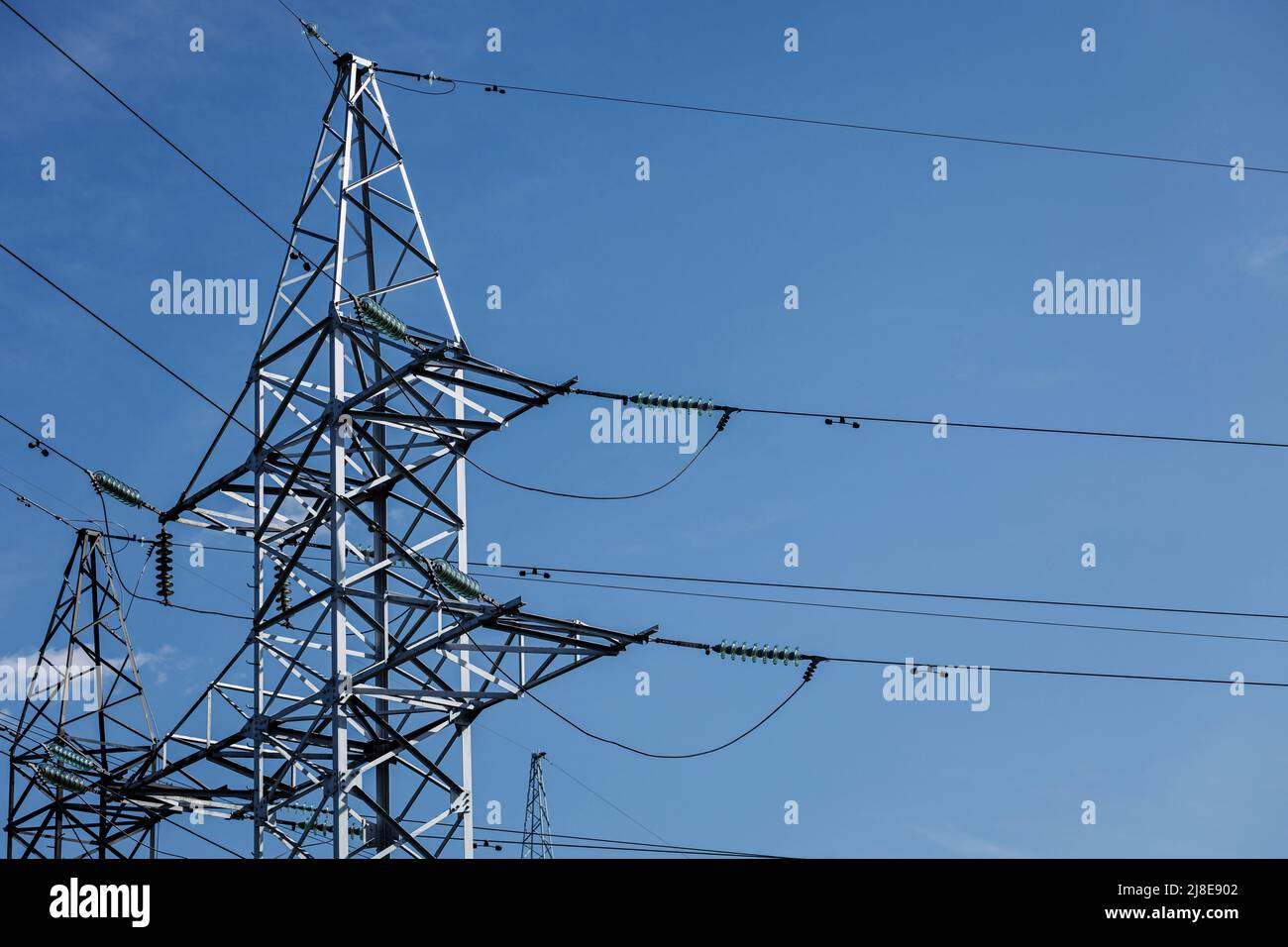 High voltage transmission towers line. Electrical net of poles Stock