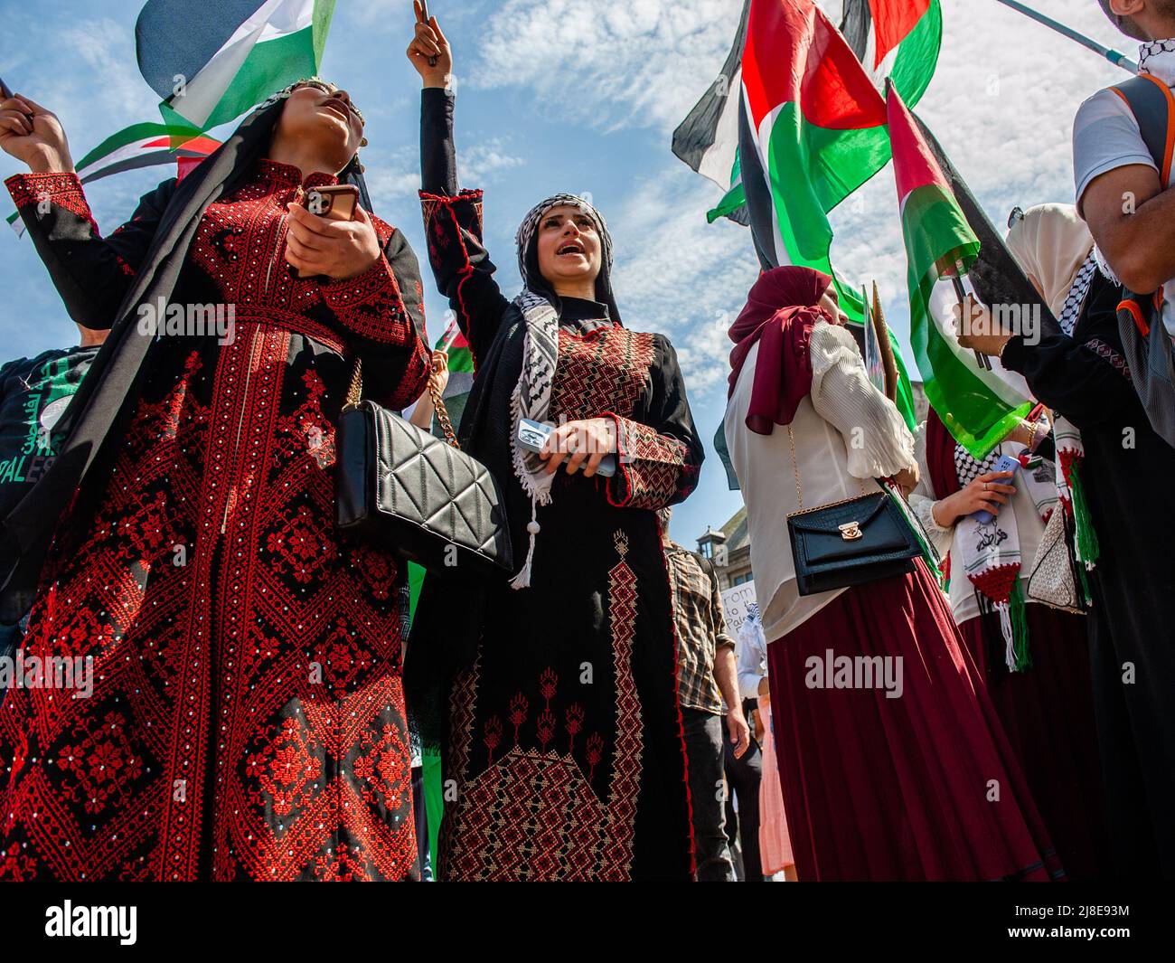 Palestinian female demonstrators are seen wearing traditional Palestinian dresses during a rally on the 74th anniversary of Nakba Day at the Dam square in Amsterdam. Palestinian demonstrators gathered for a rally at the Dam square in Amsterdam on the occasion of the 74th anniversary of Nakba Day and to condemn the murder of Palestinian-American journalist Shireen Abu Akleh by Israeli forces. The word “Nakba” means “catastrophe” in Arabic, and refers to the systematic ethnic cleansing of two-thirds of the Palestinian population at the time by Zionist paramilitaries between 1947-1949 and the nea Stock Photo
