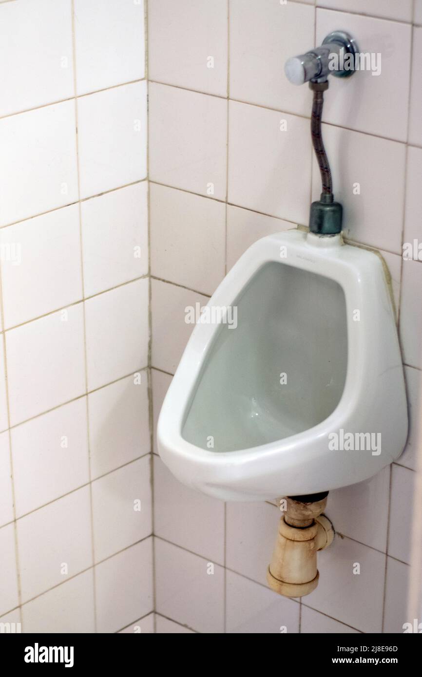 Man's toilet wc urinal with heavy use. Masculine heavily used public toilet. Public spaces for