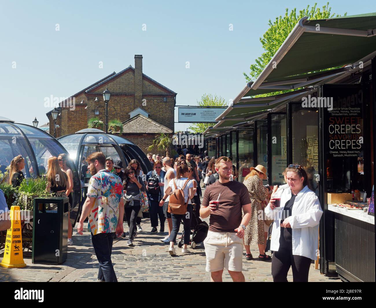 View of tourists and shoppers walking around busy Camden Market in London Stock Photo