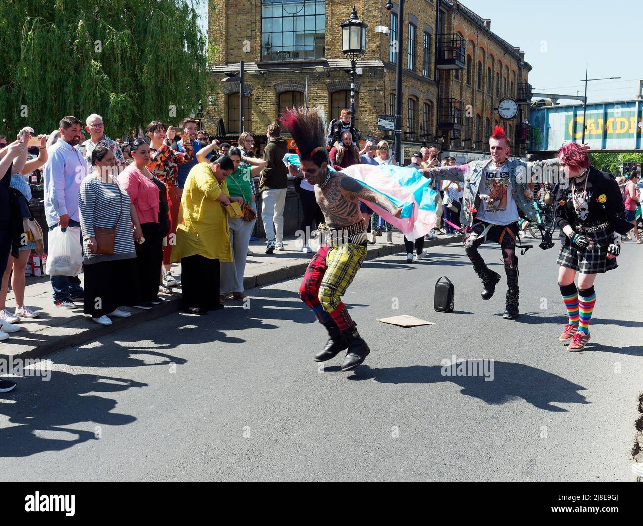 View of Camden's punks dancing with tourists on Lock Bridge in London UK Stock Photo