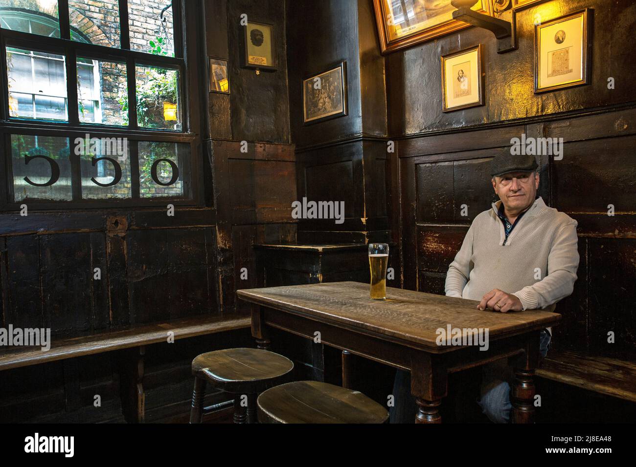 Male drinking beer in traditional pub The Ye Olde Cheshire Cheese The