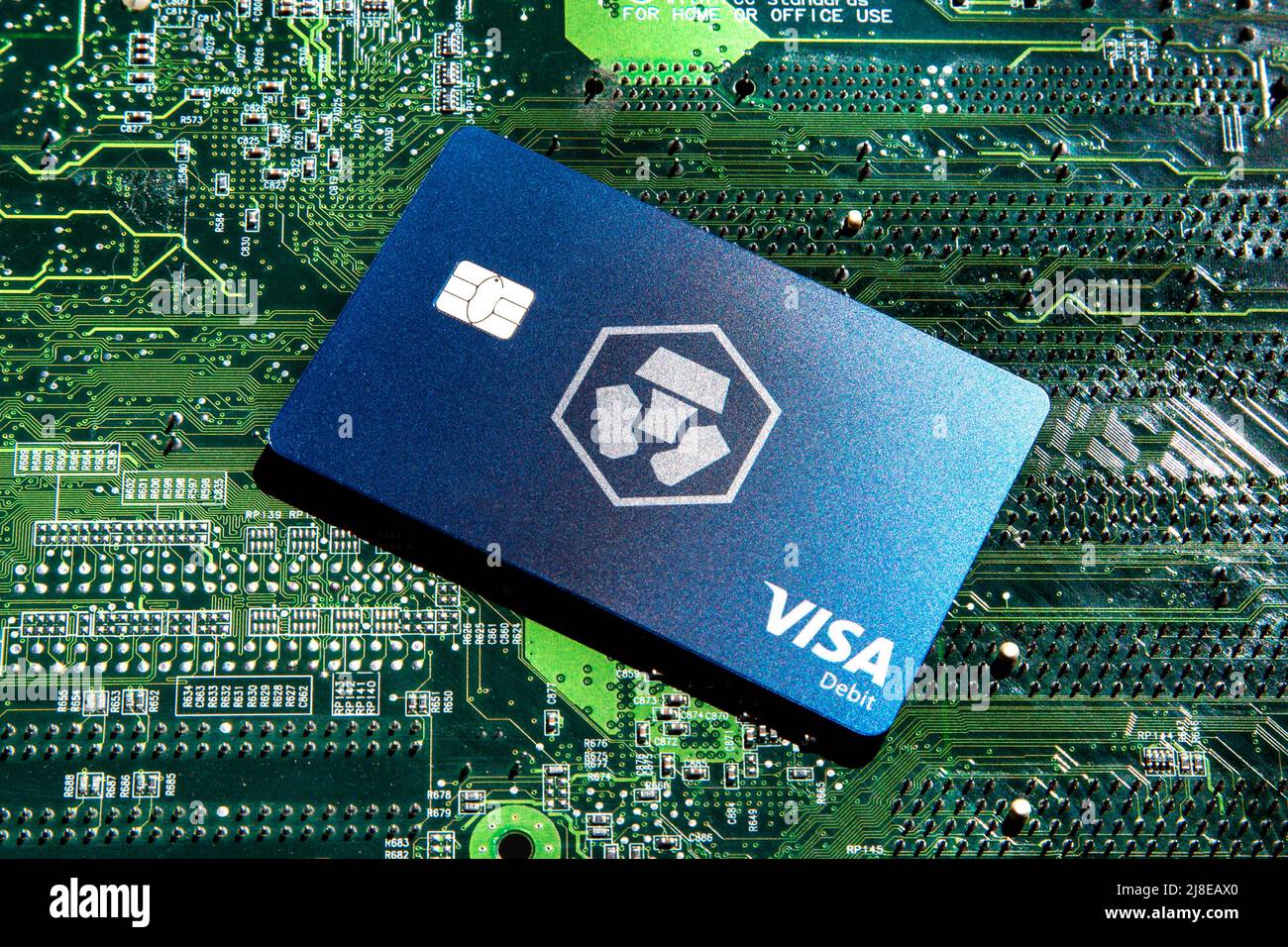 Crypto.com Visa Debit Reward Card on circuit board background Stock Photo