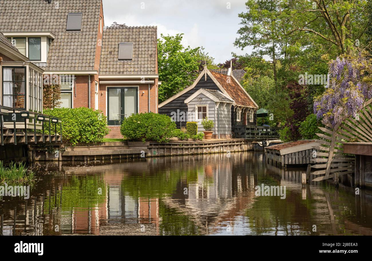 Canal in dutch village Broek in Waterland, a popular tourist destination Stock Photo