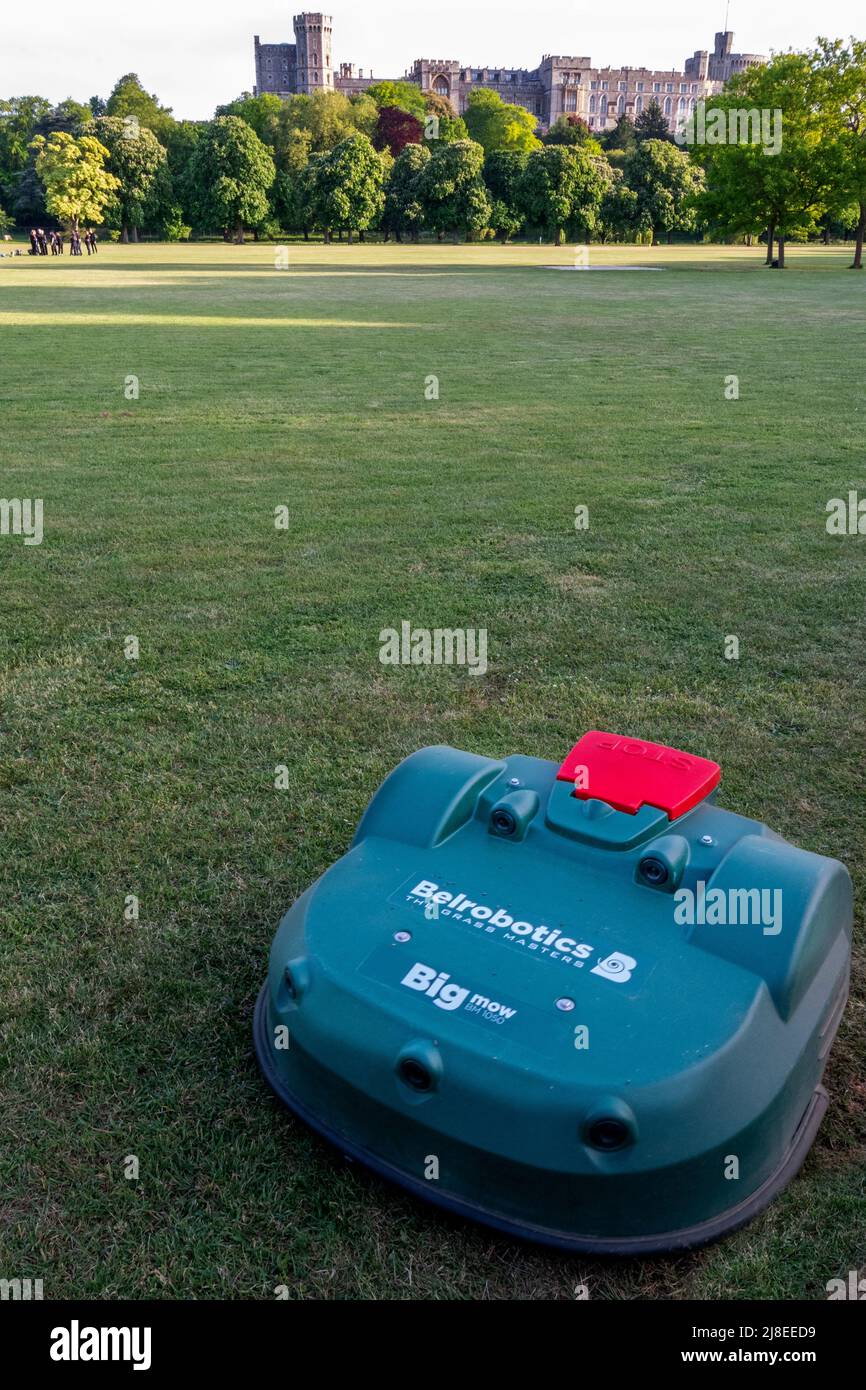 Windsor Berkshire UK 14 May 2022 Remote lawn mower  deemed with the task of cutting the grass on the lawn at Home Park, a 655-acre Royal park , and which the Royal Windsor Horse Show occupies part of it for the duration of the show Credit. Gary Blake/ Alamy Live News Stock Photo