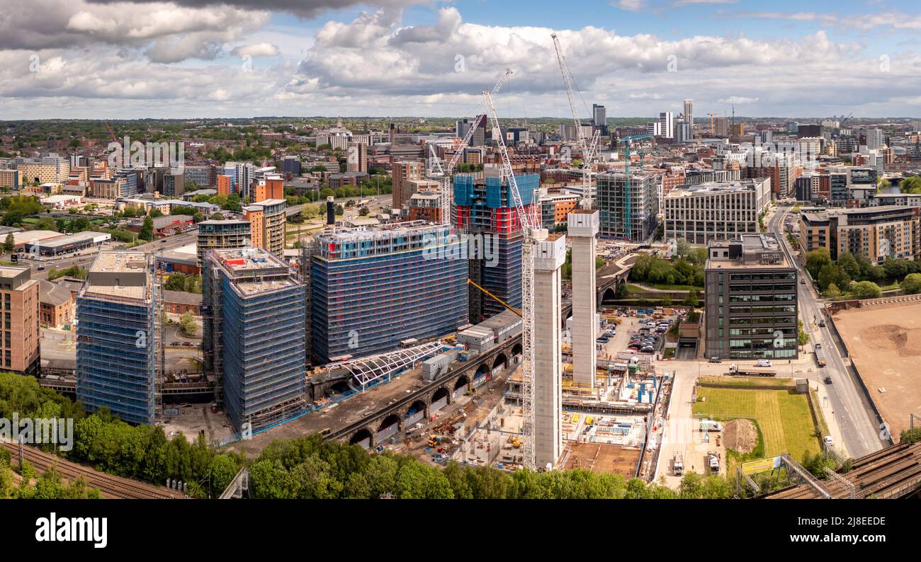 An aerial cityscape view of tall skyscrapers under construction with