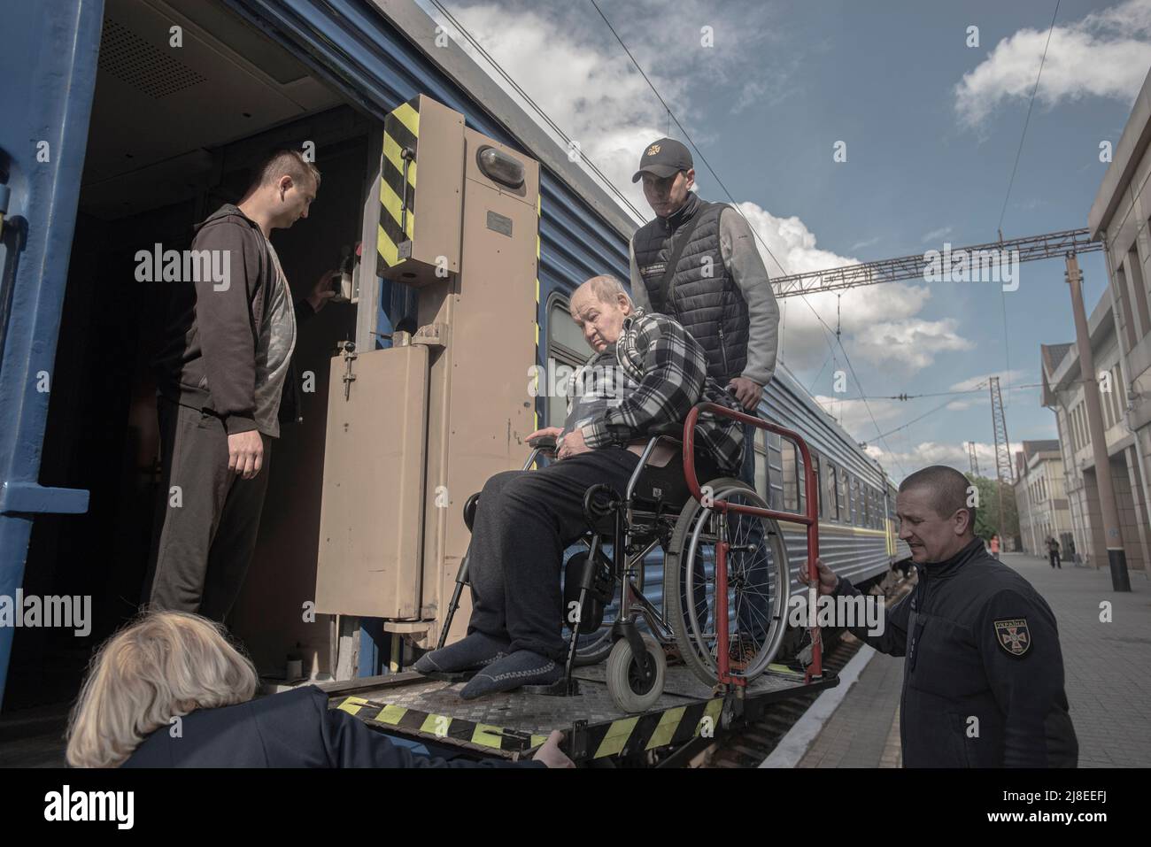Volunteers helping a handicaped man in the train station of Povrovsk where people is going to escape from Kramatorsk and outskirts due to Russian Army is close to the city.  Sunday 15th of May of 2022.The Russian invasion of Ukraine by order of Vladimir Putin in February 2022 produced large displacements of people and a great reaction from public opinion and political forces around the world. Russian military forces entered Ukraine territory on Feb. 24, 2022. (Photo by Andoni Lubaki/Sipa USA) Stock Photo