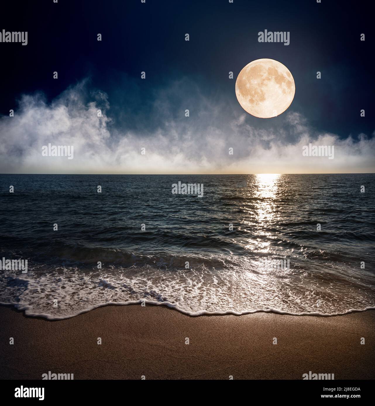 Sandy beach and moon at night Stock Photo