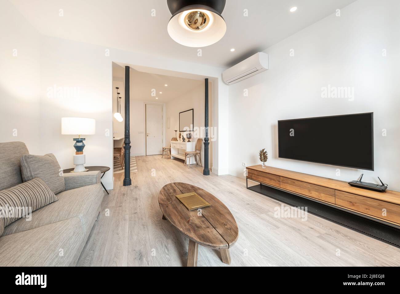 living room with twoseater sofa upholstered in light fabric, oblong