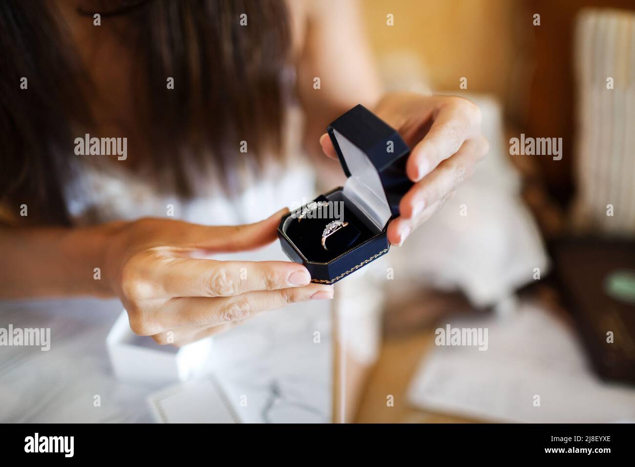 Box with rings in the hands of the bride. Stock Photo