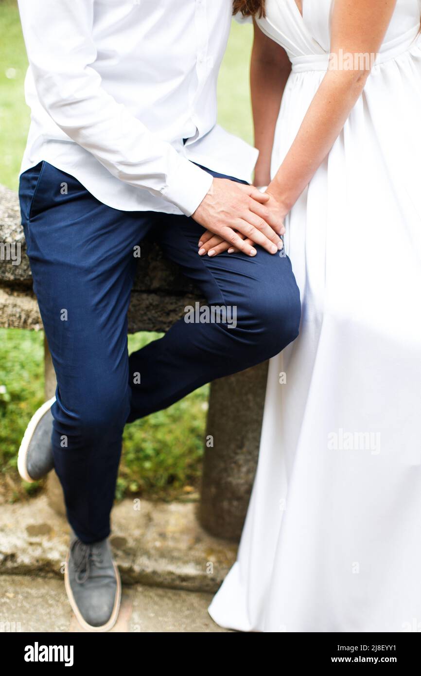 Bride and groom holding hands in the park Stock Photo - Alamy
