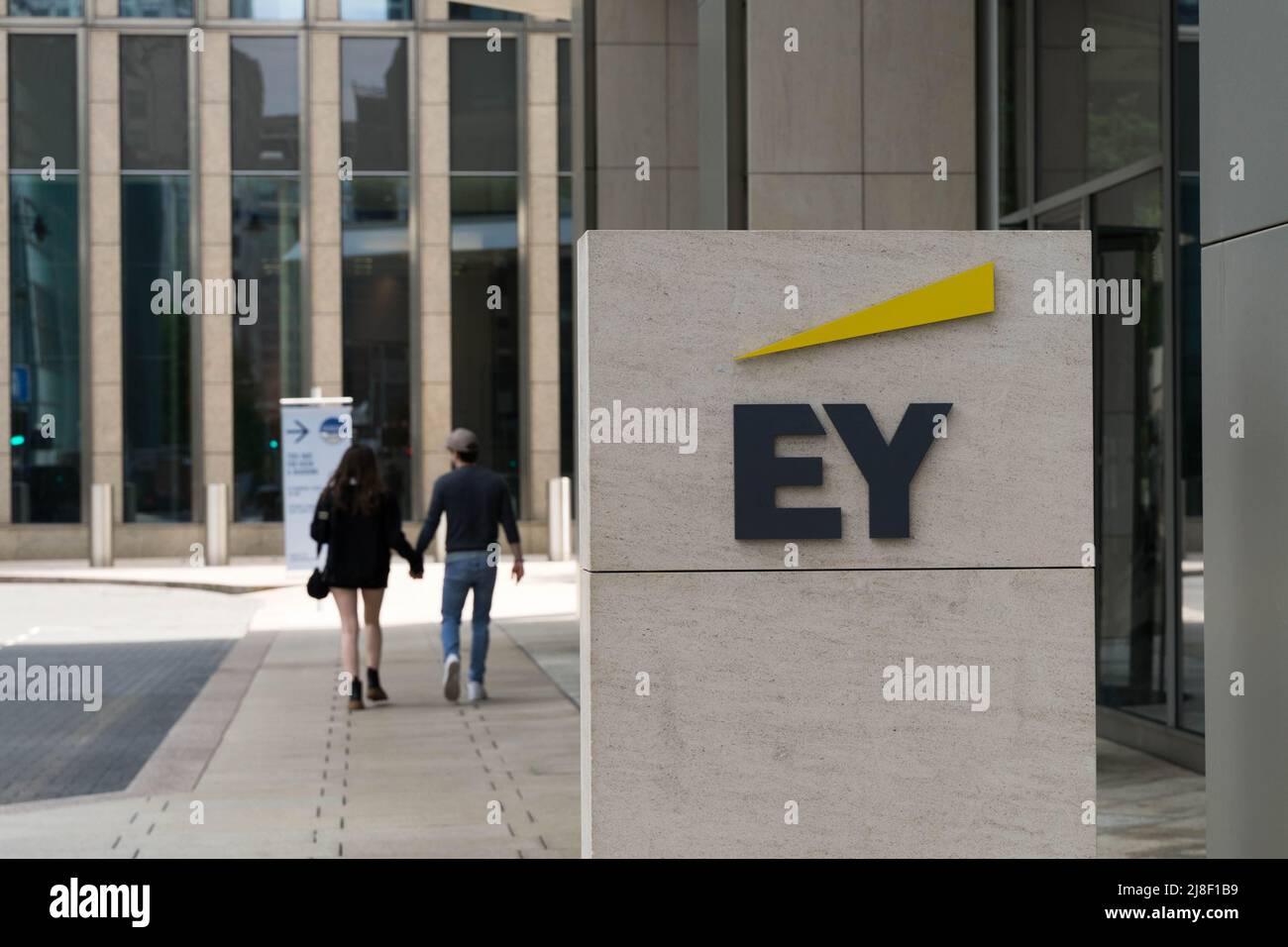 EY logo outside its canary Wharf building London England UK Stock Photo