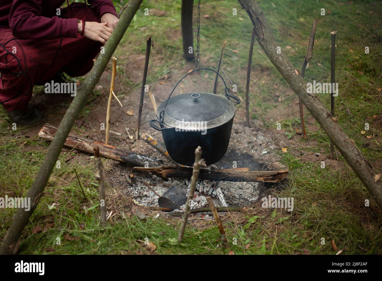 Cauldron or camping kettle over open fire outdoors Stock Photo - Alamy