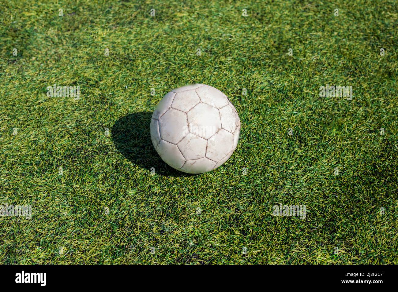 Soccer ball on lawn. Details of football. White ball in stadium. Sports