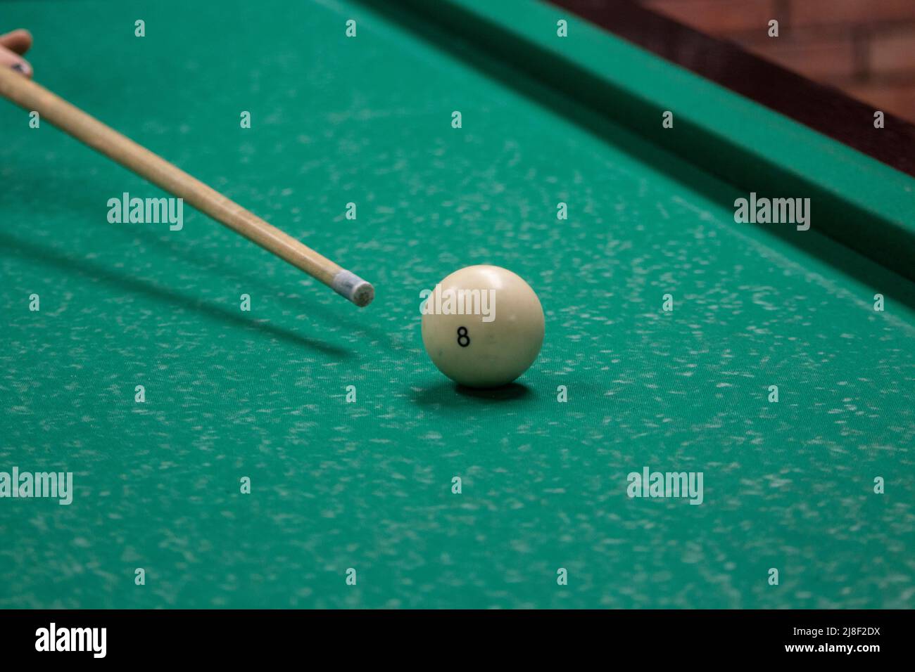 Billiard balls are white. Green billiard table. Playing in bar. Sports