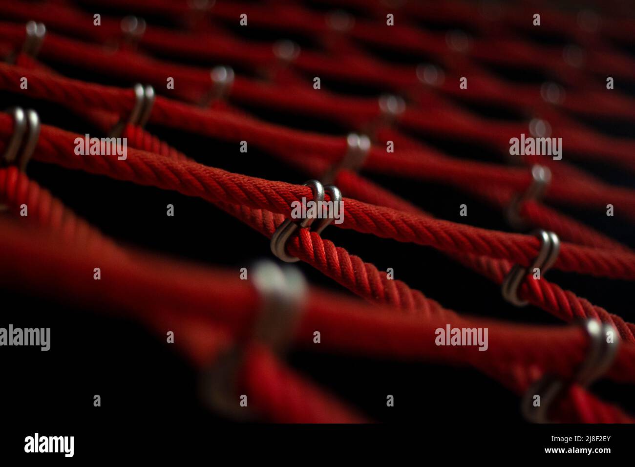 Ropes in the playground. Climbing net, shot close-up. Ropes fastened ...