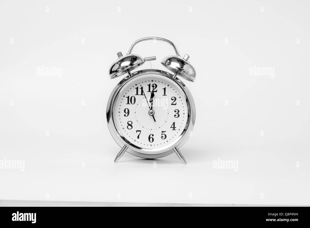 Retro alarm clock isolated on white background. Stock Photo