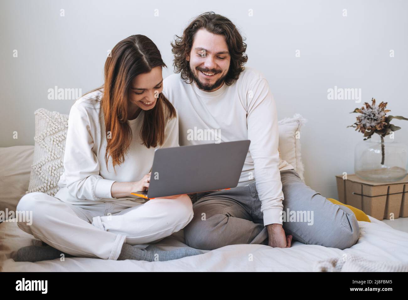 Happy couple young family using laptop on bed at the home Stock Photo ...