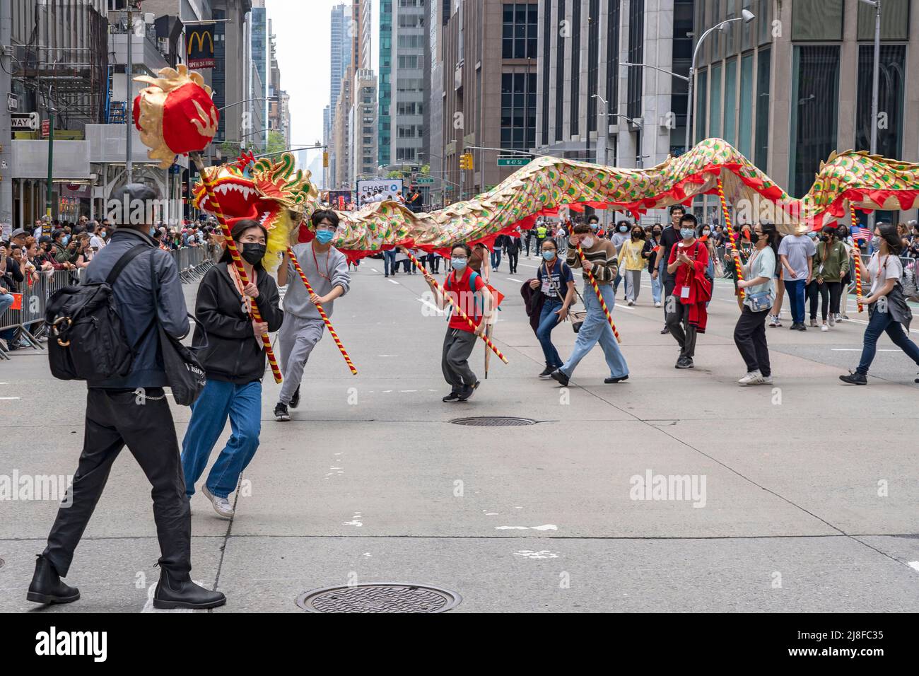 NEW YORK, NEW YORK - MAY 15: Participants with a traditional Chinese Dragon costumes run up and down Sixth Avenue during the New York City first Asian American and Pacific Islander Heritage Cultural Parade on May 15, 2022 in New York City. Credit: Ron Adar/Alamy Live News Stock Photo