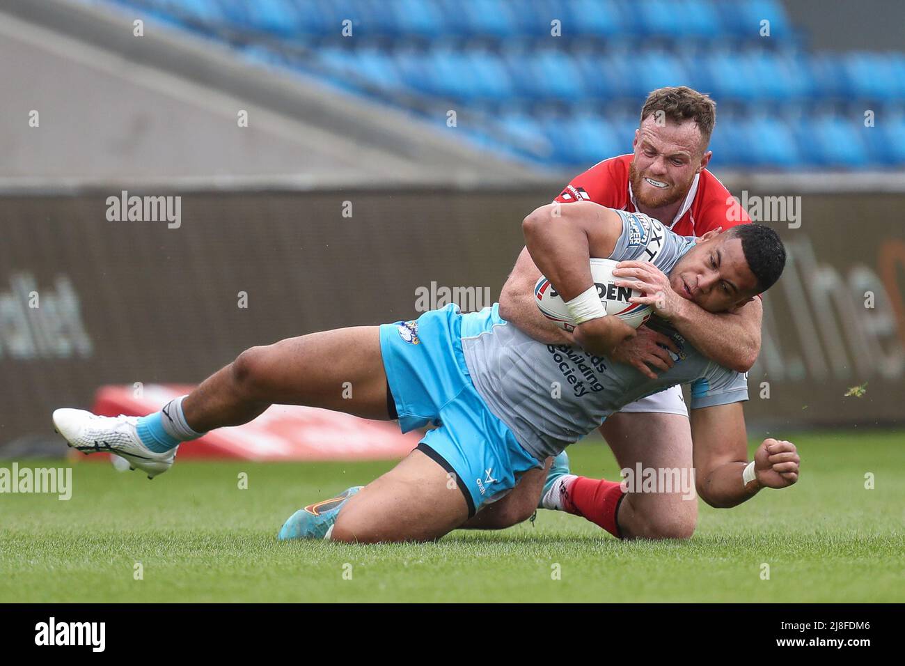 Eccles, UK. 15th May, 2022. Joe Burgess #5 of Salford Red Devils brings down David Fusitu'a (2) of Leeds Rhinos in Eccles, United Kingdom on 5/15/2022. (Photo by James Heaton/News Images/Sipa USA) Credit: Sipa USA/Alamy Live News Stock Photo