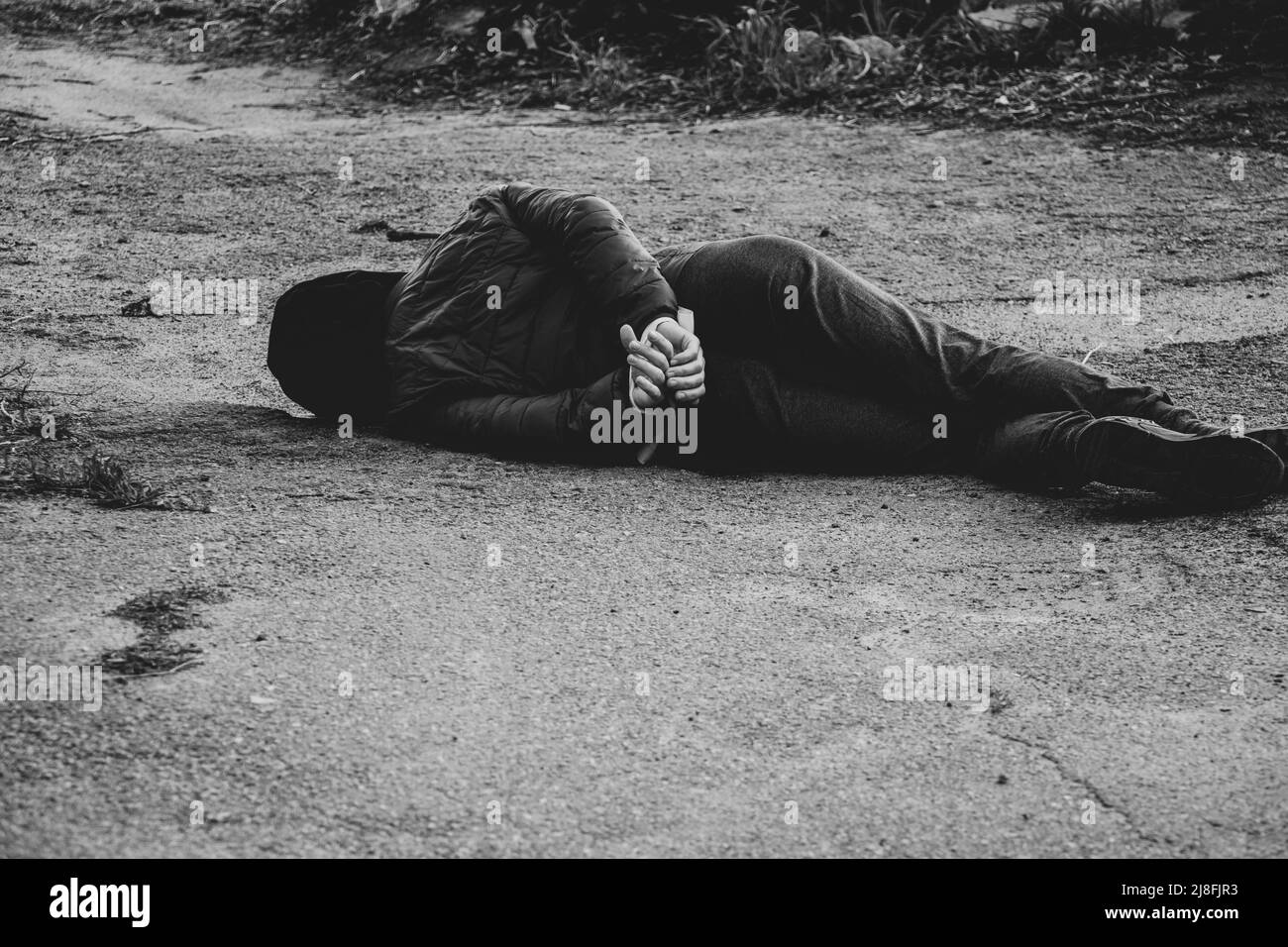 A dead Ukrainian woman lies on the street with her hands tied with a white rope and was killed in the back in Ukraine, a death protest in the city of Stock Photo