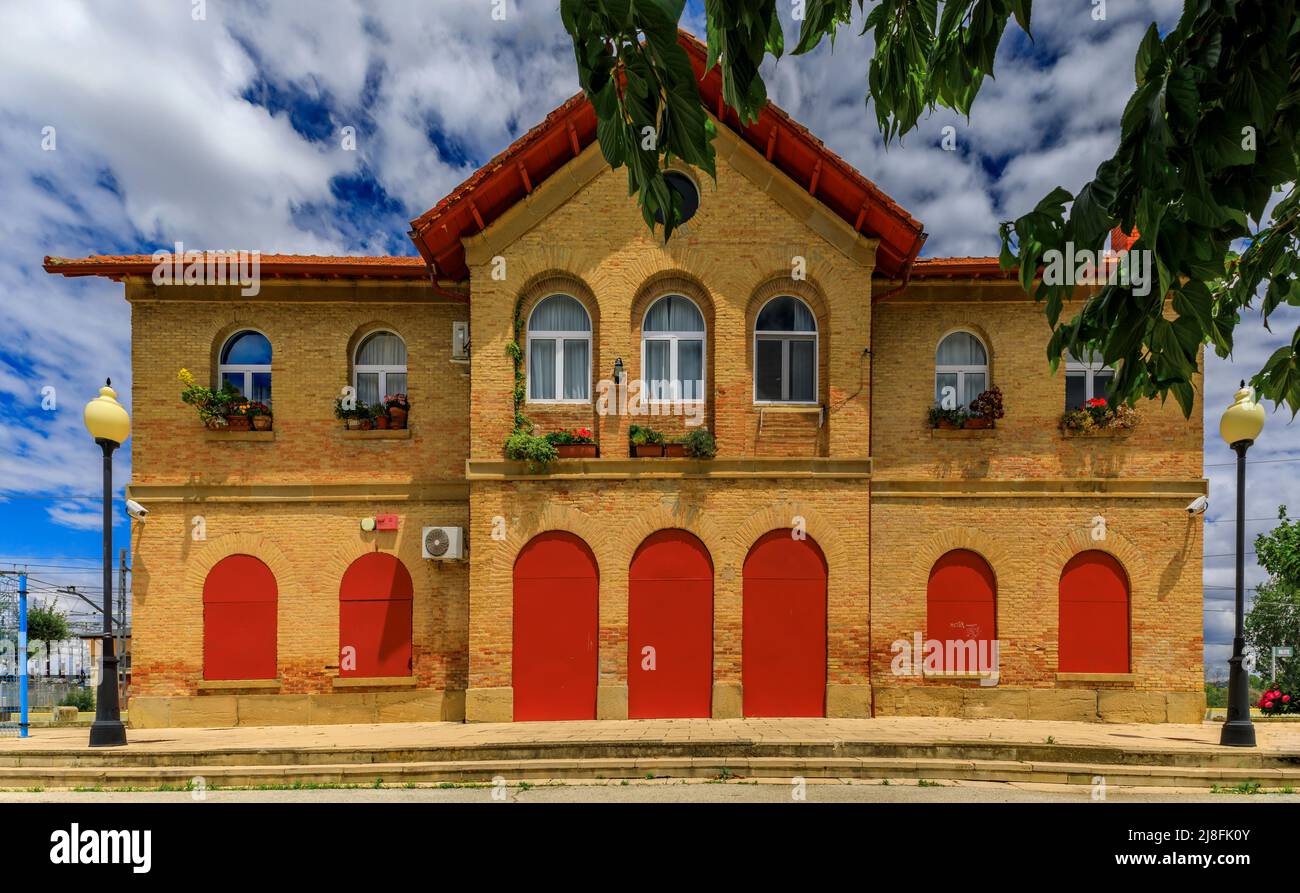 Brick facade with red shutters and doors of the Olite or Erriberri train station in Navarra, North of Spain Stock Photo