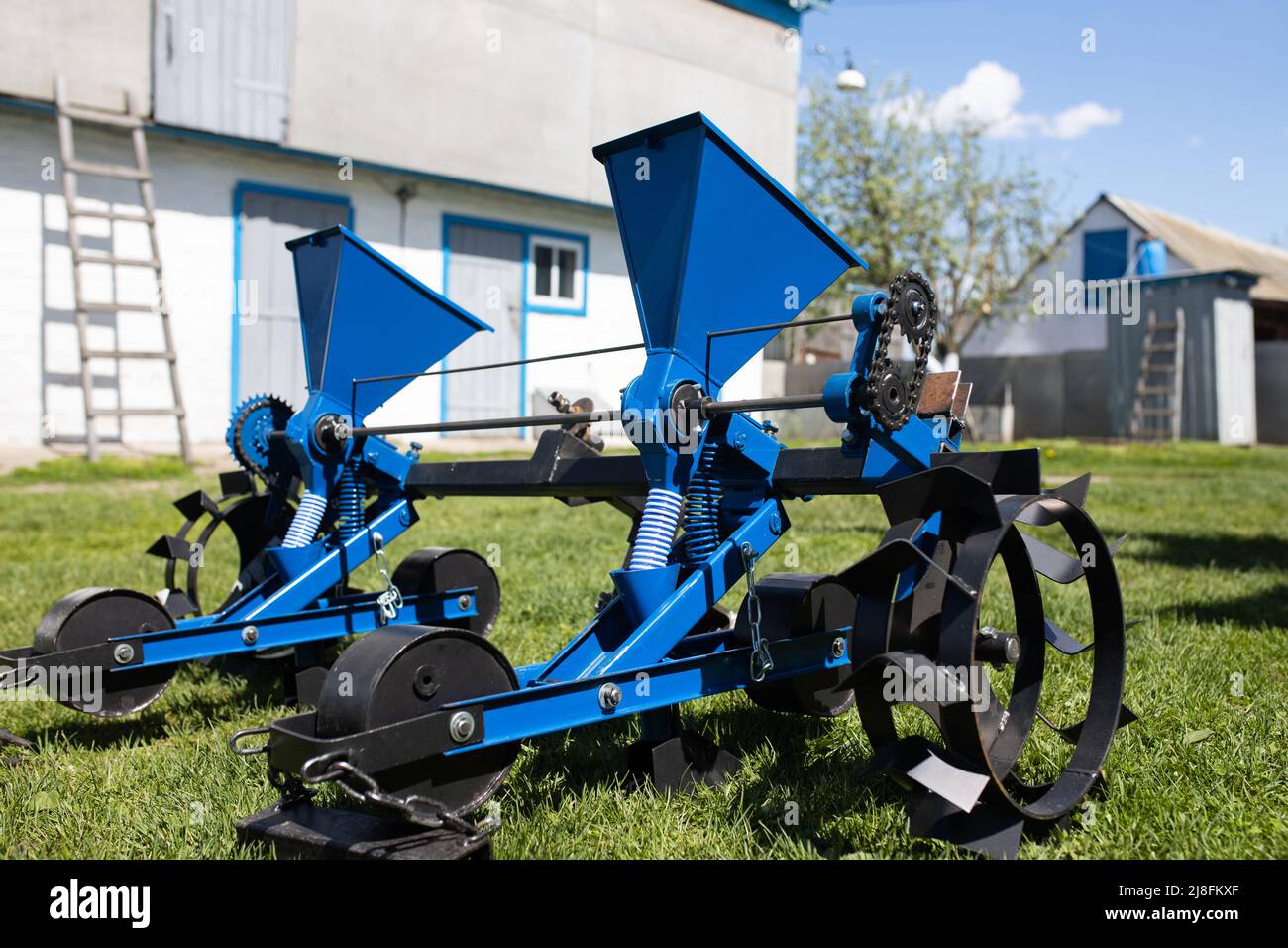 Blue seeder for agricultural machinery on the grass Stock Photo