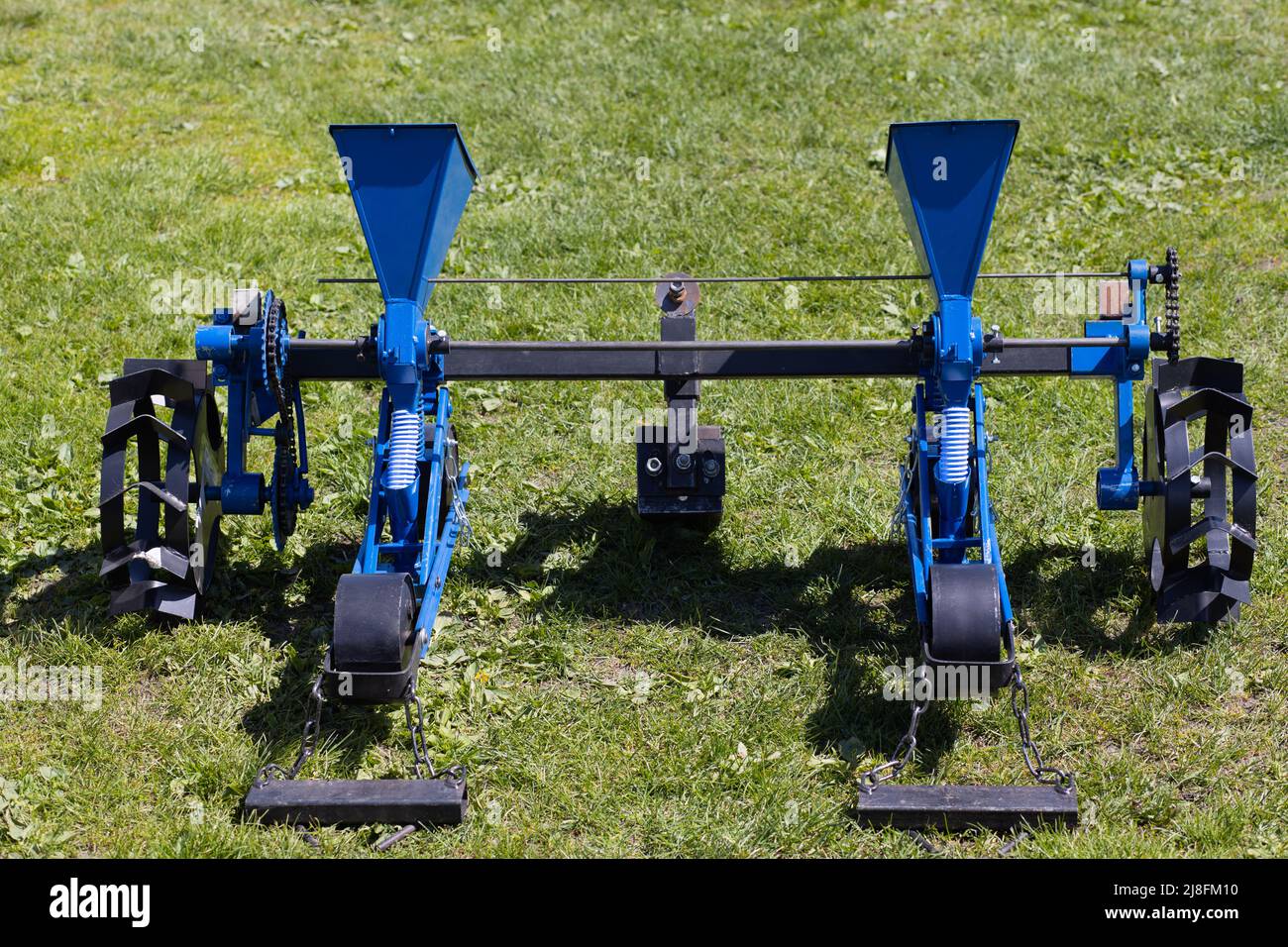 Blue seeder for agricultural machinery on the grass Stock Photo Alamy