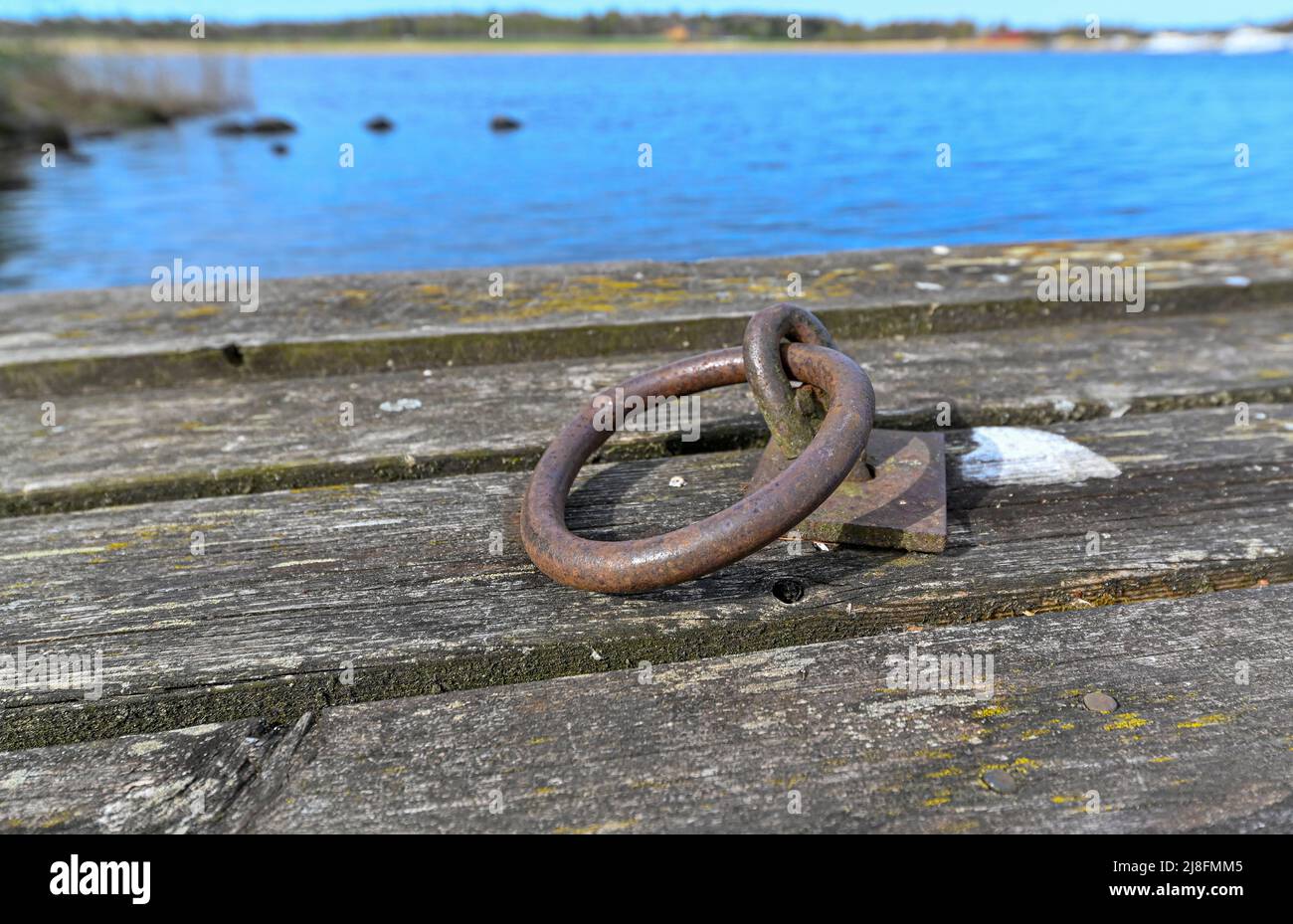 old jetty with round rusty mooring ring Stock Photo - Alamy