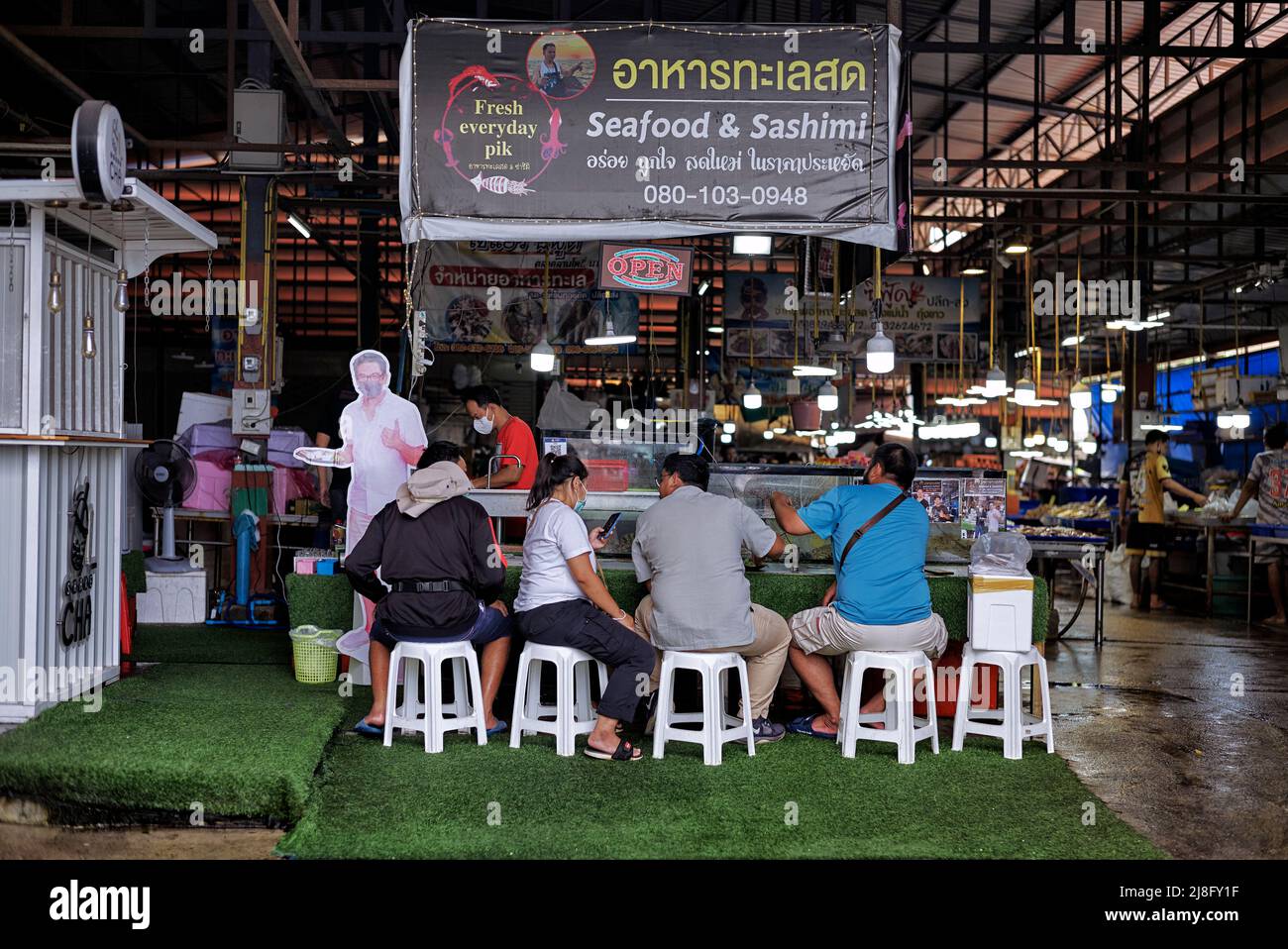 People eating outdoor at a Thailand seafood market stall. Southeast Asia Stock Photo