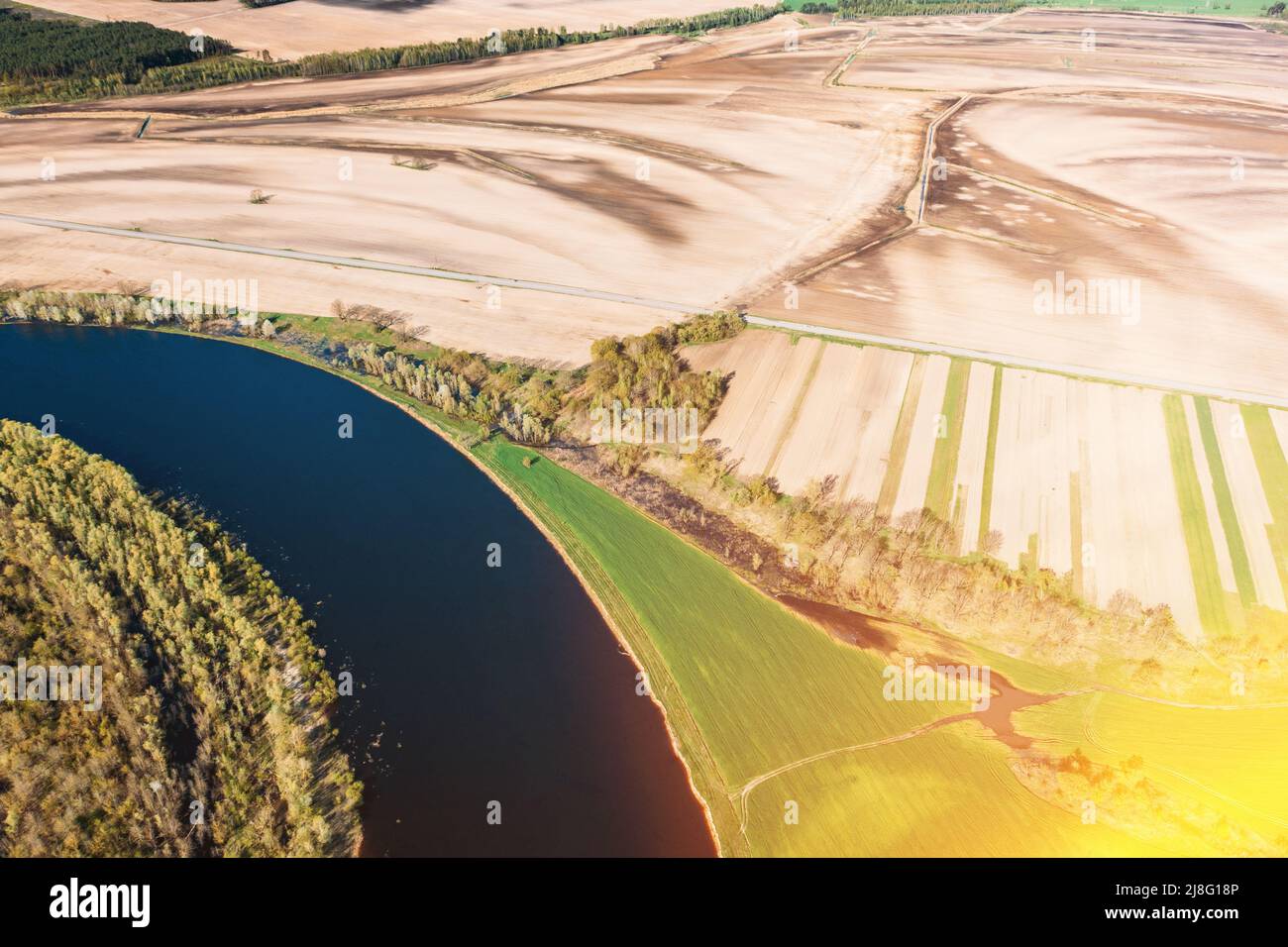 Aerial View Fields And River Landscape In Sunny Spring Summer Day. Top View Of Nature, Bird's Eye View. Trees Standing In Water During Spring Flood Stock Photo