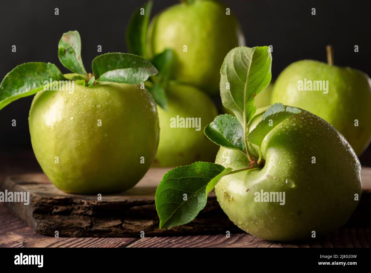 Raw Granny Smith apples. Green fresh fruits on dark background Stock