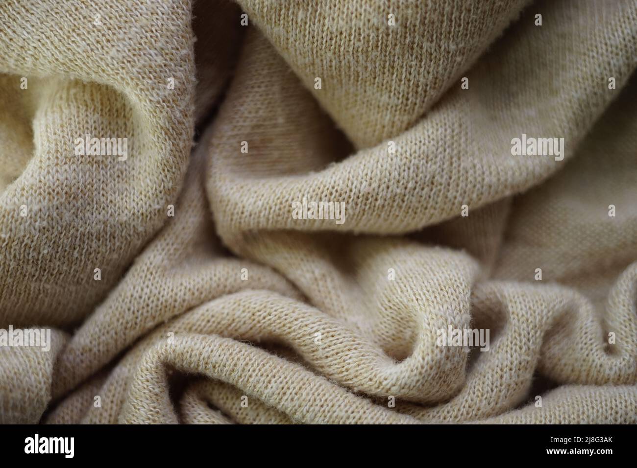 Knitted creamy background, beige sweater cozy pattern. Stock Photo