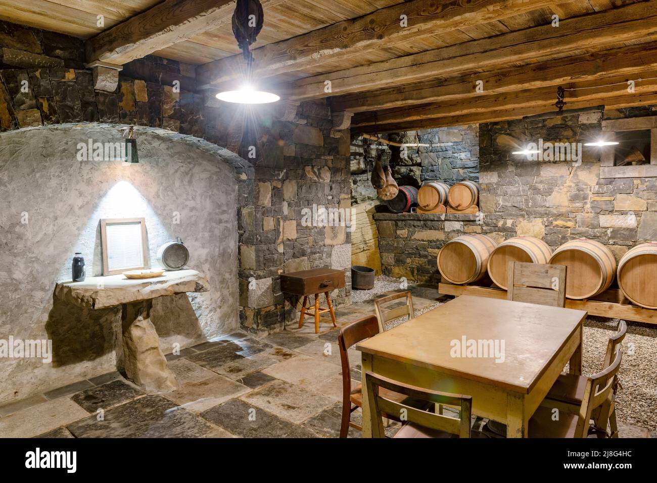 Old wine cellar in Vipava valley, Slovenia. Traditional distillery in Slovenia. Wine vault with old wooden wine barrels. Stock Photo