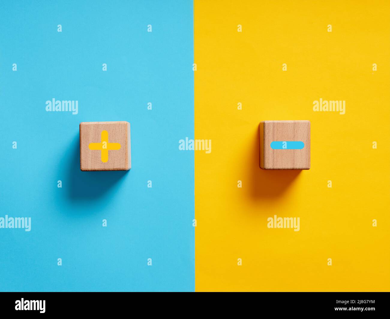 Pros and cons or strengths and weaknesses concept. Plus and minus symbols on blue and yellow background. Stock Photo